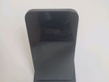 a black phone that is sitting on a white table