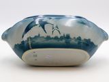 a blue and white vase with birds on it