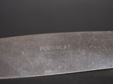 a close up of a knife on a table