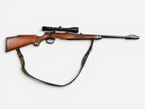 an old rifle with a sling attached to it on a white background