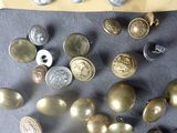 a lot of buttons that are laying on a table