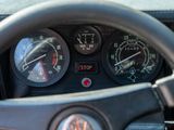 steering wheel of a car with gauges and a stop button
