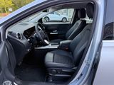the interior of a car with the door open and the driver ' s seat down