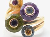 an image of a close up of a ring with different colored stones