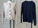 three sweaters on a mannequin stand in front of a white wall