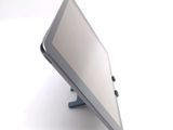 a tablet computer sitting on a stand on a white surface