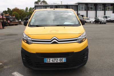 a small yellow van parked in a parking lot