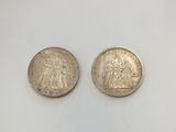 two silver coins with the image of jesus and mary on them
