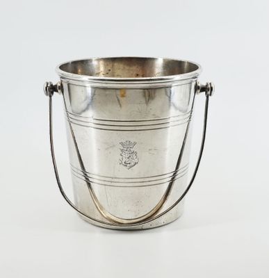 an antique silver plated ice bucket with handles on a white background