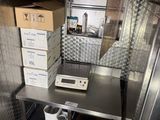 a small kitchen with a lot of boxes on the counter