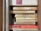 a box full of books that are stacked on top of each other