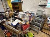 a cluttered room with a ladder and a window