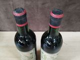 two bottles of wine that are sitting on a table