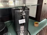 a coffee machine sitting on a counter with a cup on it