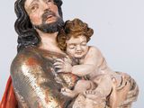 statue of a man holding a child in his arms