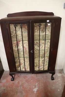 a cabinet that has a glass door on top of it