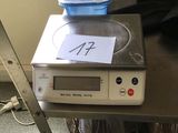 a scale on a table with a plastic container on top