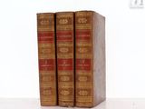 three books that are sitting on a white table