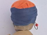 a doll that is wearing a blue and orange outfit
