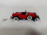 an image of a red toy car on a white surface