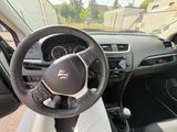 a steering wheel and dashboard of a car in a parking lot