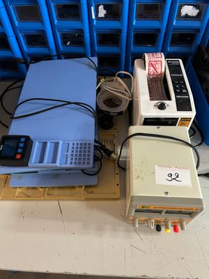 several electronic devices are sitting on a pallet in front of blue bins