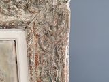 an old picture frame with a picture of a bird perched on top of it