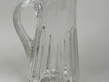 a glass pitcher that is sitting on a table
