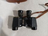 a small pair of binoculars sitting on a white surface
