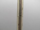 a close up of a metal object on a white surface