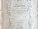 an old book with writing on it sitting on a table