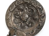 a silver plate with a design on it