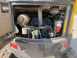 a back end of a construction vehicle with a large engine