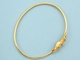 a close up of a gold bracelet on a blue surface