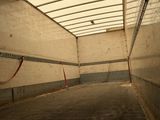 a man riding a skateboard down a ramp in a building