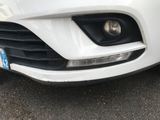 a close up of a white car with a license plate on it