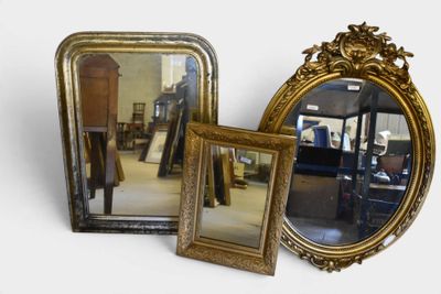 two mirrors sitting next to each other on a table