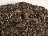 a close up of a metal sculpture of birds and flowers
