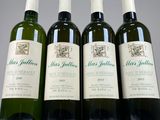 three bottles of wine are lined up on a table