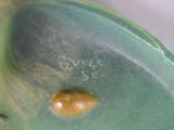 a close up of a green plate with a brown spot on it