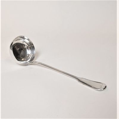 a silver spoon with a spoon handle on a white surface