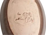 a close up of a vase with writing on it