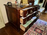 a dresser with drawers and a mirror in a room