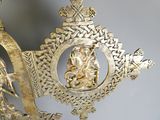 a gold statue of a man and a woman on a boat