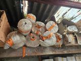 many rolls of paper wrapped in orange ribbons on a wooden table