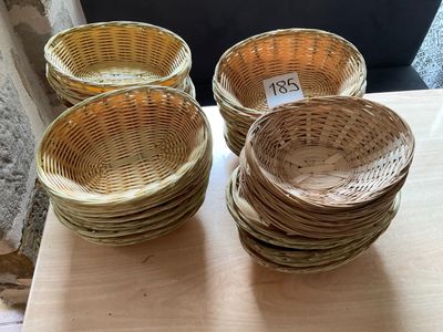 four wicker baskets sitting on top of a table next to each other