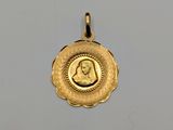 a close up of a gold coin with a woman ' s face on it