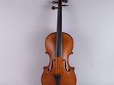 an old violin sitting on top of a white surface