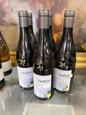 several bottles of wine are lined up on a glass table