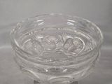 a clear glass bowl with a flower design on it